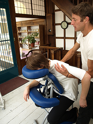 Owner Tom giving a customer a back rub